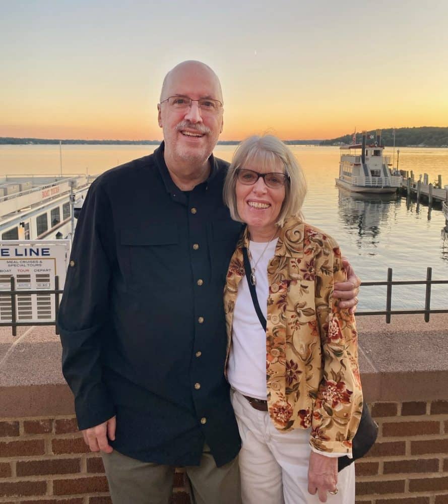 A retired couple enjoying the waterfront at sunset